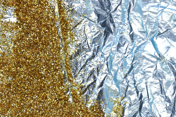 istock Gold glitter on a  blue foil 1290469728