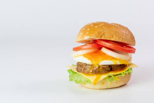 istock Burger, hamburger, cheeseburger, in bun with lettuce, tomato, onion, fried egg, delicious fast food, on white background. 1290470452