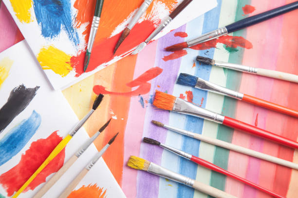 istock Paintbrush on watercolor painted background. Art. Hobby 1290470967