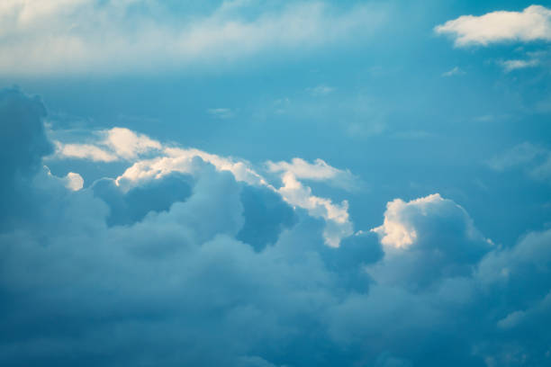 istock Thunderstorm cloud in the sky at sunset texture background. 1290472031
