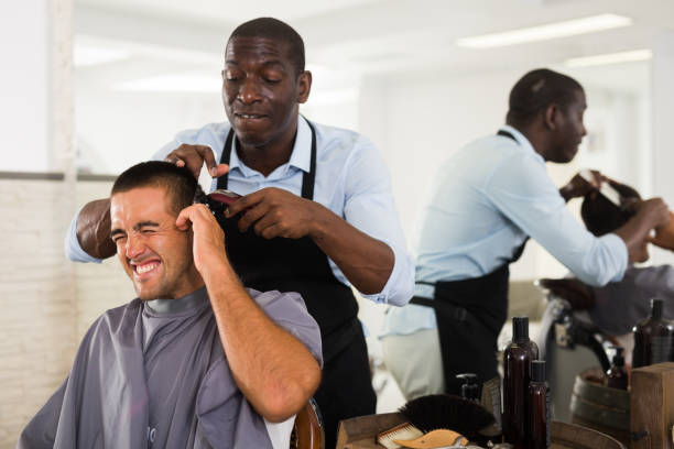 istock Barber hurting male client 1290472095