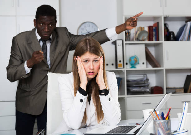 istock Upset woman with angry boss 1290472387