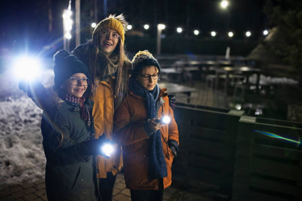 istock Kids walking at night with flashlights 1290472705