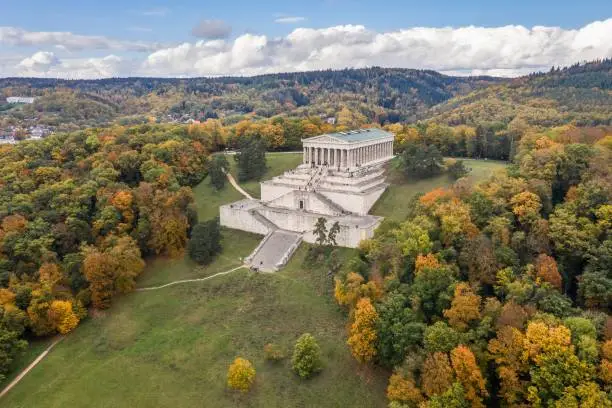 Picture of an aerial view with a drone of the Walhalla building in ancient Greek architecture as a memorial for important persons of German language with sky clouds tree mountain in Regensburg, Germany