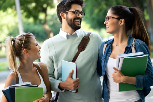 istock Group of happy students studying, preparing together for exam ourdoor 1290474524