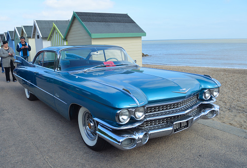 Felixstowe, Suffolk, England -  May 07, 2017:  Classic Blue Cadillac Automobile parked on seafront promenade.