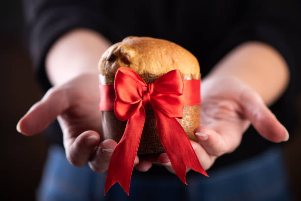 istock young woman holds a panettone a typical Christmas 1290475028