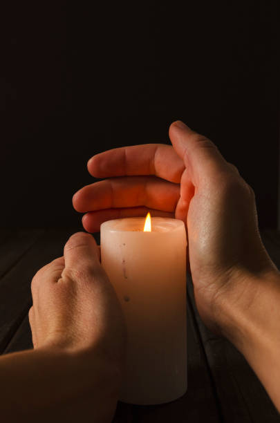 istock Woman holding cylindrical candle with flame, dark atmosphere 1290475204