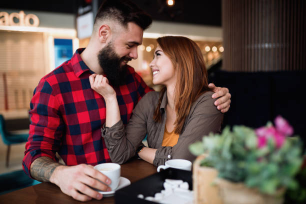 istock Young beautiful couple in coffee bar 1290476375