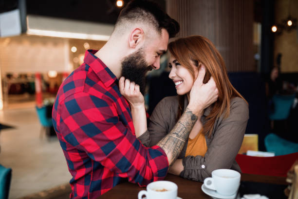 istock Young beautiful couple in coffee bar 1290476430