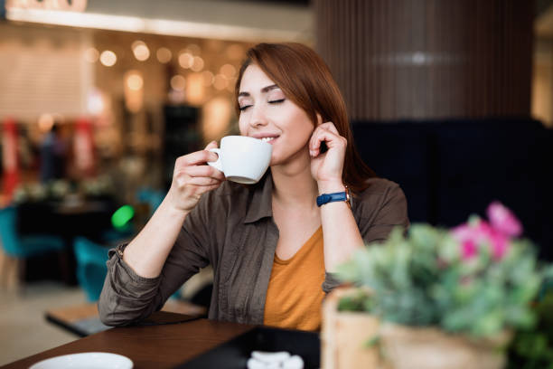 istock Beautiful young woman in coffee bar 1290476458