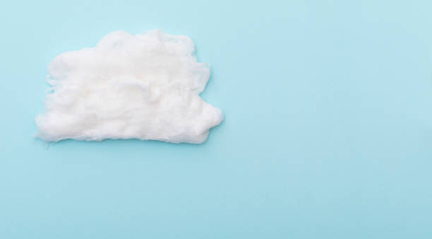 Cumulus clouds by cotton wool on blue surface, layout for ideas, space for text Cumulus clouds by cotton wool on blue surface, layout for ideas, space for text cotton cloud stock pictures, royalty-free photos & images