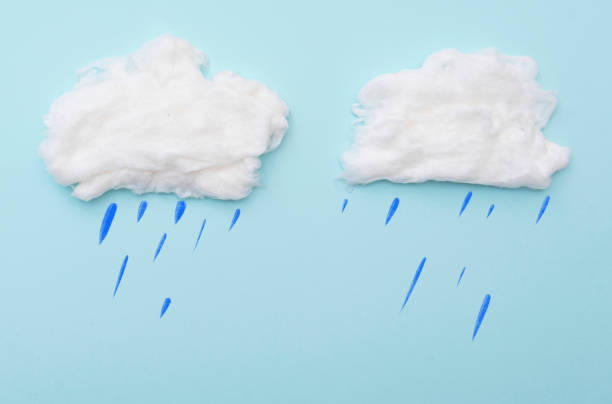 istock Cumulus clouds by cotton wool with rain drops on blue surface, layout for ideas, space for text 1290477348