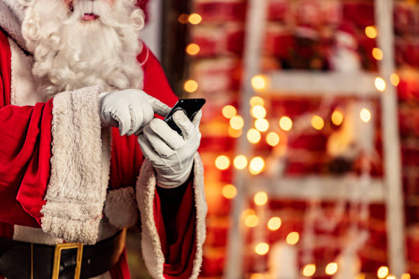 istock Santa Claus checking e-mails on phone 1290479623