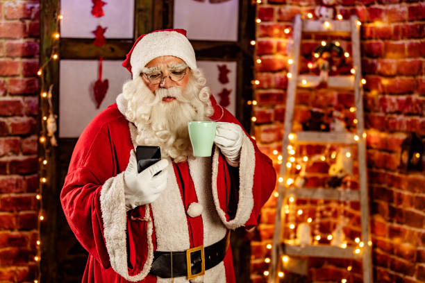 istock Santa Claus using smartphone in cafeteria 1290479874