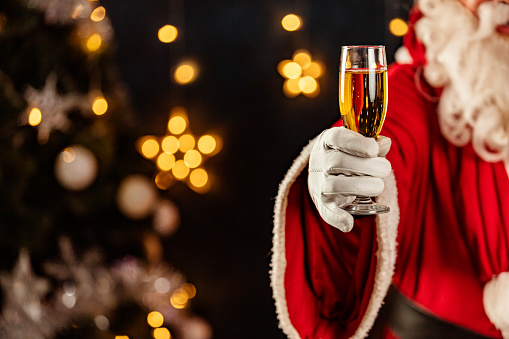 Santa Claus with a glass of sparkling wine champagne.