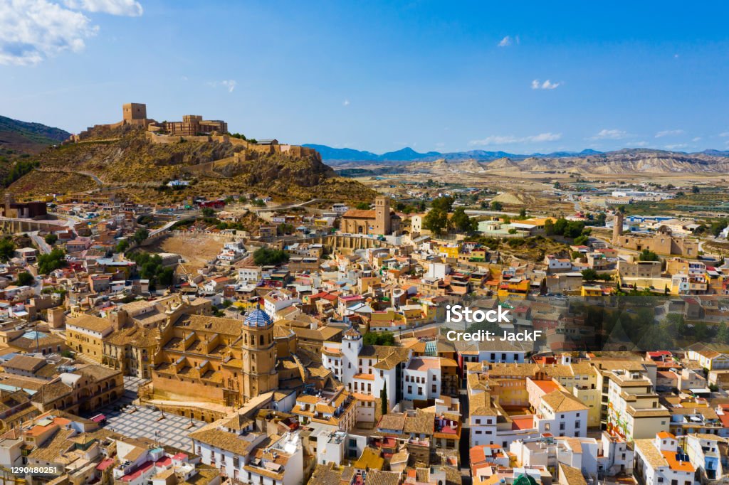 Aerial view of Lorca cityscape with Collegiate church, Spain Aerial view of Spanish city of Lorca overlooking Collegiate church of St. Patrick and ancient castle on hilltop on sunny autumn day Lorca Stock Photo