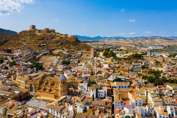 Aerial view of Lorca cityscape with Collegiate church, Spain Aerial view of Spanish city of Lorca overlooking Collegiate church of St. Patrick and ancient castle on hilltop on sunny autumn day murcia stock pictures, royalty-free photos & images