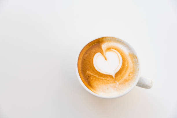 istock flat lay cappuccino with heart shape, against white background 1290482539