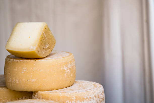 istock Pile of cheese against light background 1290482593