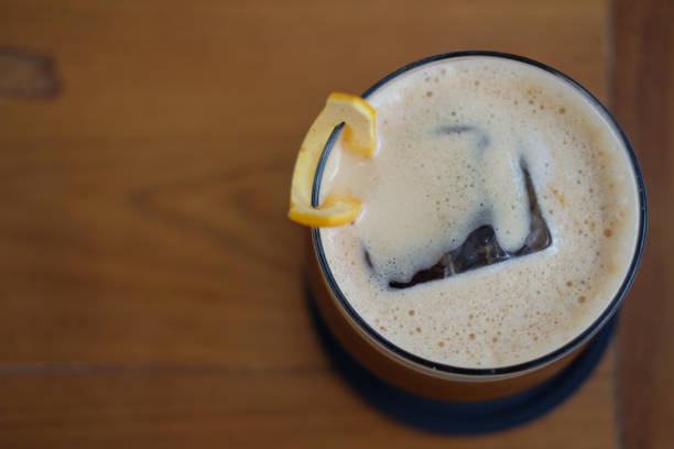 istock iced coffee mixing with orange syrup garnished with orange peel 1290483875
