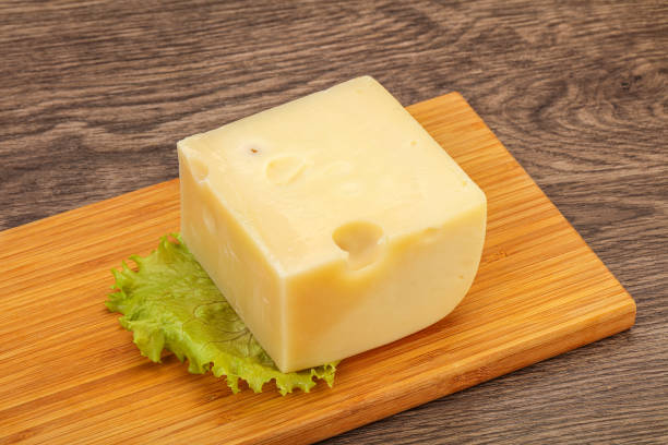 istock Emmental cheese over wooden board 1290485218