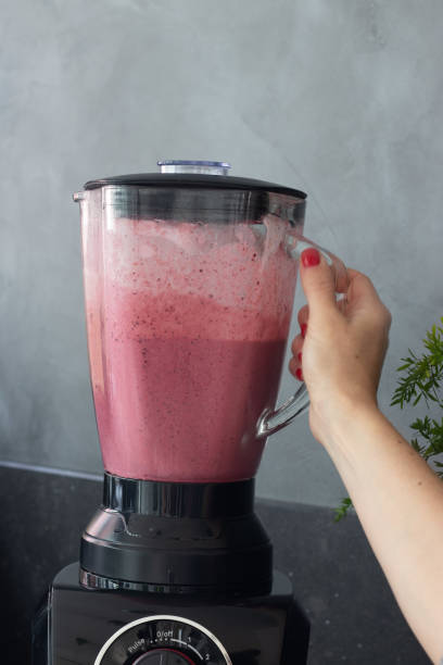 istock Preparing a fruit smoothie or pink milk shake 1290485722