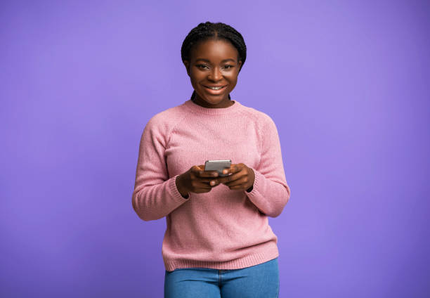 istock Mobile Offer. Positive Black Millennial Female Posing With Smartphone In Hands 1290488236