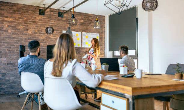 istock Female manager in a work meeting with her workers 1290488339