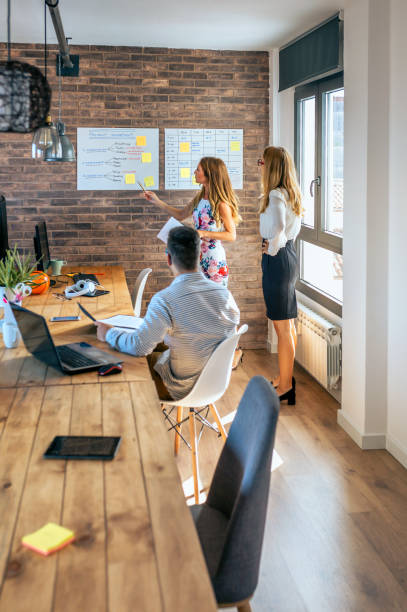 istock Female manager in a work meeting with her workers 1290488344
