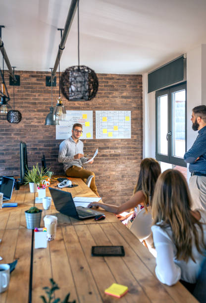 istock Coach giving a talk to workers in an office 1290488346