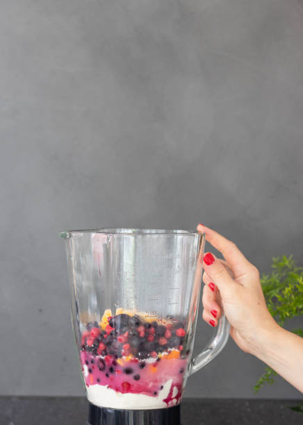 istock Preparing a fruit smoothie or pink milk shake 1290488425