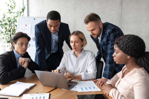 istock Multiethnic Business Team Working On Laptop Together Sitting In Office 1290490893