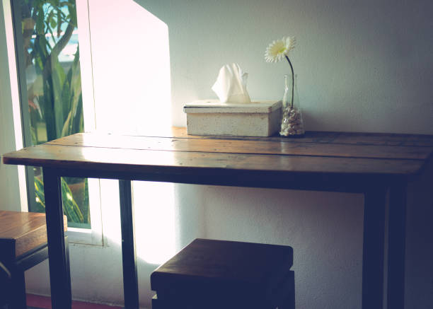 istock artificial white gerbera flower decorating on wooden table in living room 1290491333