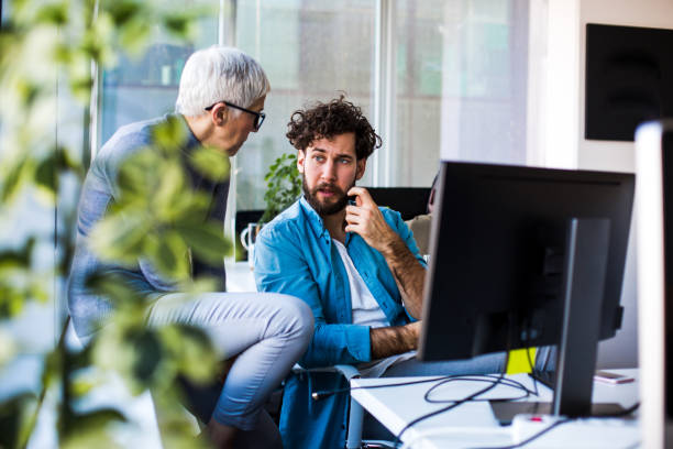 istock Two colleagues in office talking about job, thinking. Teamwork. 1290492278