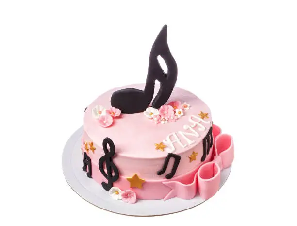 Festive multicolored sugar paste cake for a musician. Treble clef and notes, main theme. High quality photo
