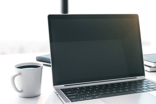 istock Modern laptop with blank screen on white table with cup of coffee. Mock up. 3D Rendering 1290493556