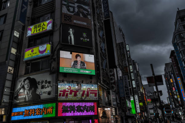 Tokyo, Japan - April 11, 2020:The first weekend after the declaration of a state of　emergency in Tokyo.Usually, Shinjuku attracts a lot of people on weekends, but on this day there were very few.A message from Yuriko Koike, the governor of Tokyo, is projected on a screen in a commercial building.