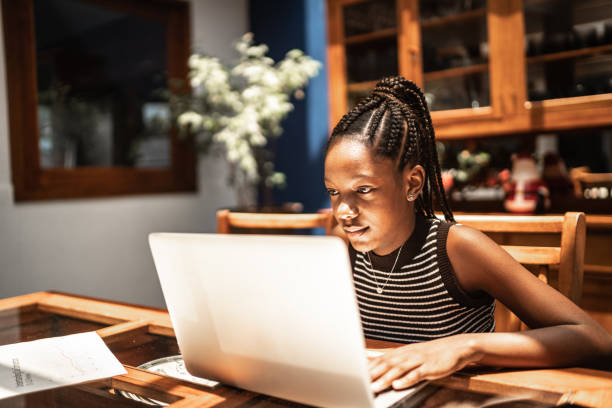 teenager-mädchen mit laptop zu hause (homeschooling oder ein video ansehen) - schoolgirl teenager teenage girls teenagers only stock-fotos und bilder