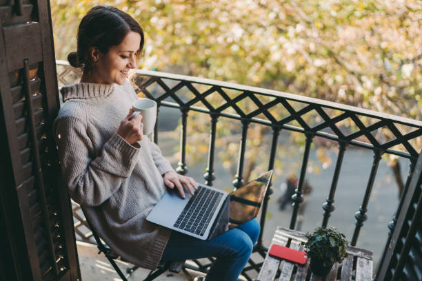 istock Woman at terrace enjoying a video call 1290494055