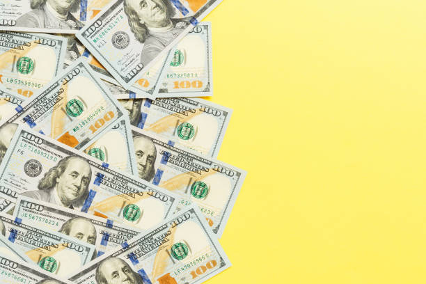 istock Top view banknotes on colored desk with copy space on top. one hundred dollar bills with stack of money in the middle. Top view of business concept 1290494973
