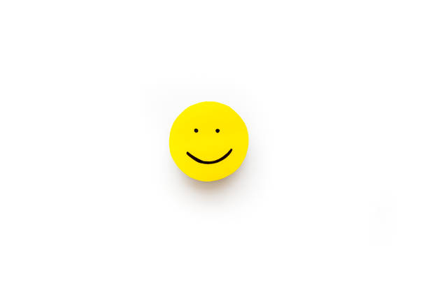 istock Smiling face emotion concept. Smile face on paper banner, top view 1290495299