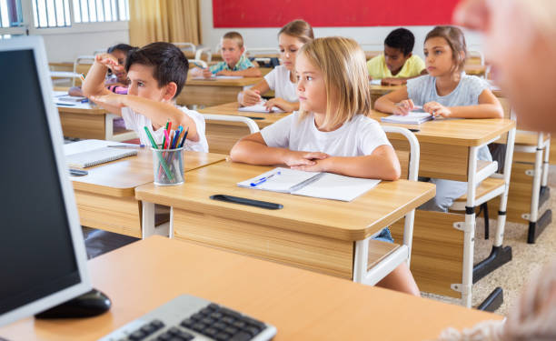 istock Group of focused children working at class 1290497137