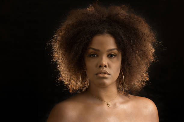 istock Attractive curly haired black woman with makeup 1290497374