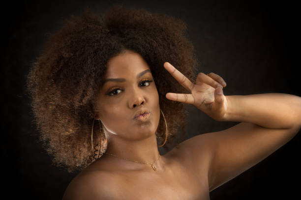 istock Cool black lady showing V sign at camera 1290497396