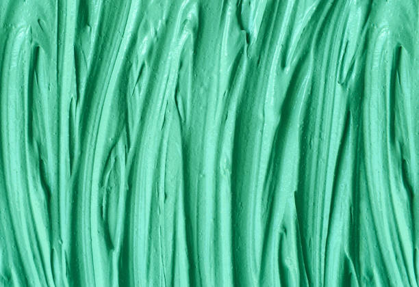 istock Green cosmetic clay (kelp facial mask, face cream, spirulina body wrap) texture close up, selective focus. Abstract background with brush strokes. 1290499019
