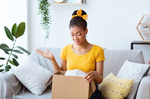 istock Frustrated black woman unpacking wrong box, delivery mistake 1290499025