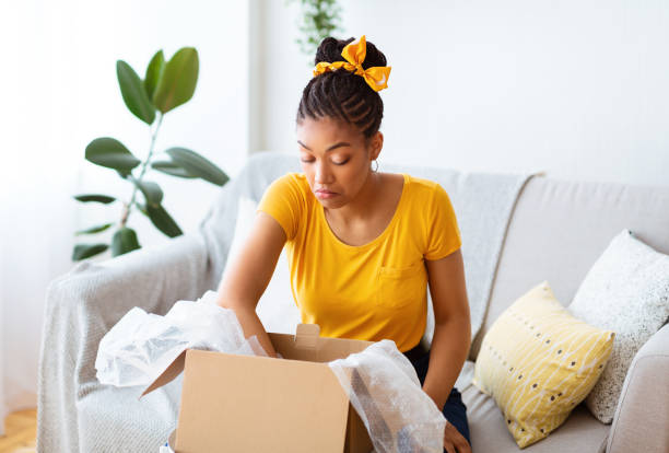 istock Frustrated black lady unpacking wrong parcel, delivery mistake 1290499050