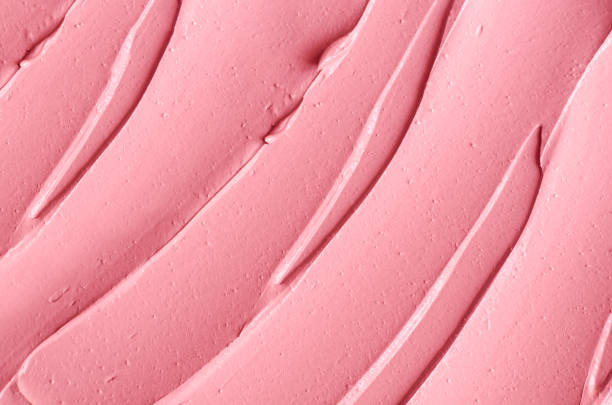 istock Rose cosmetic clay (alginate facial mask, face cream, body wrap) texture close up, selective focus. Abstract background with brush strokes. 1290499569