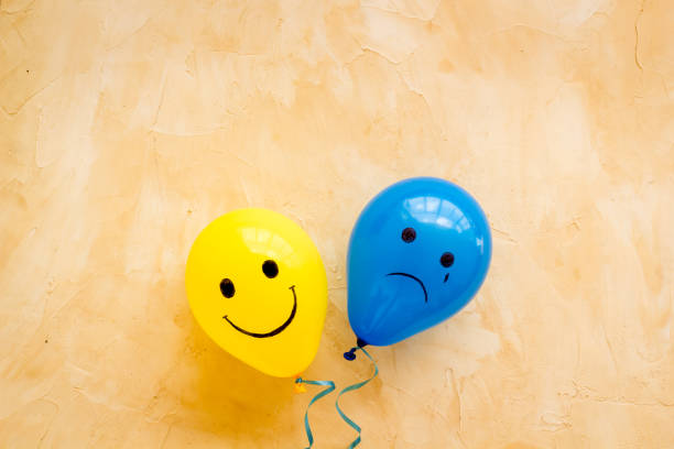 istock Emotions concept - happiness and sadness on the colored ballons. Top view 1290499800